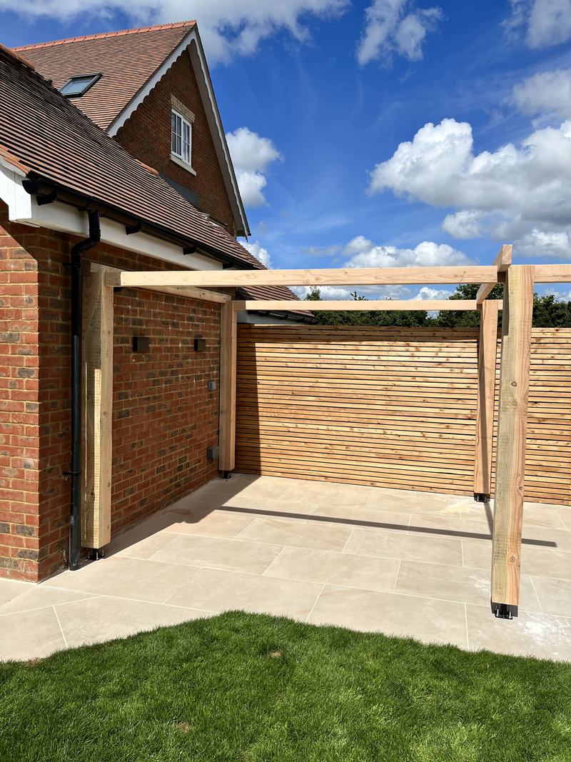 Pergola frame: Posts and beams set out over the patio.