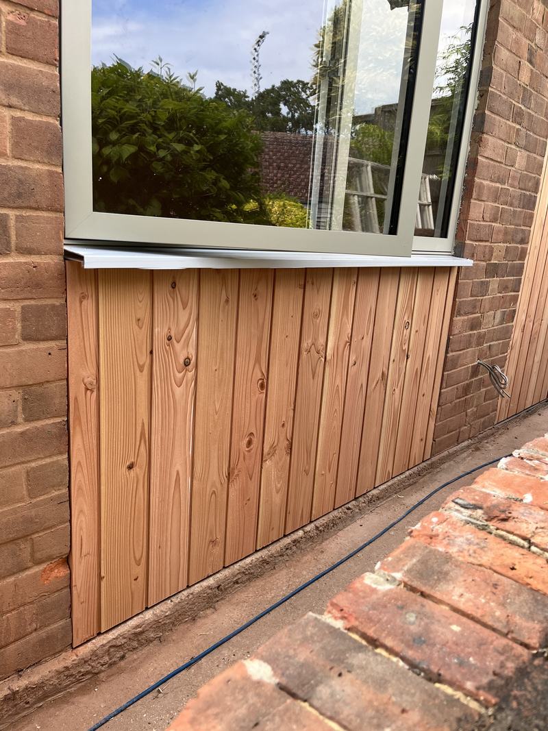 New windows: A new window set into the brickwork, with timber cladding beneath.
