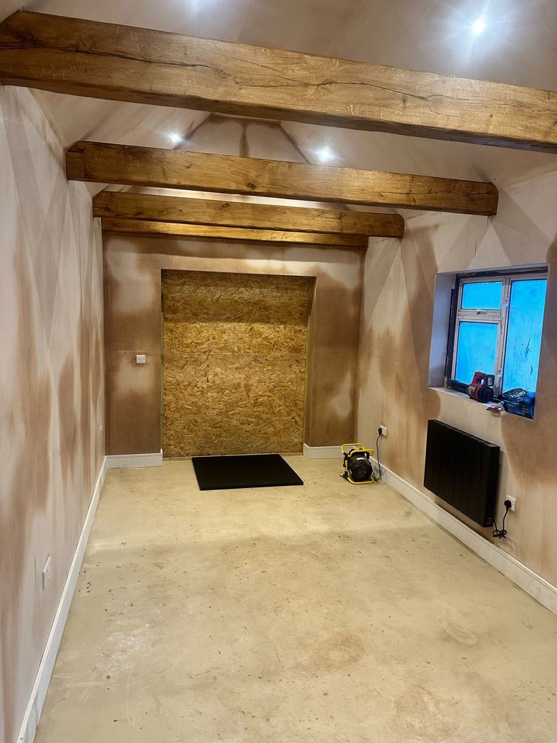 Plastering: Walls plastered and radiator in, ready to finish.