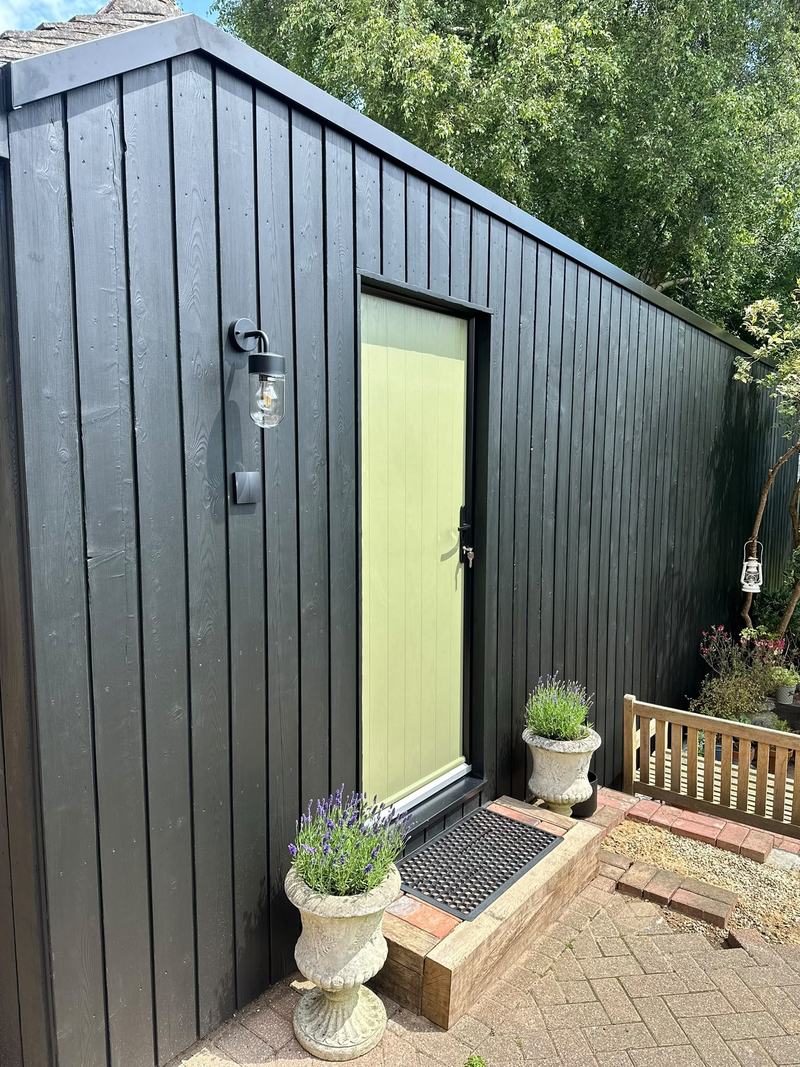 Garden music studio clad in sho sugi ban, with a green door, in Tunbridge Wells